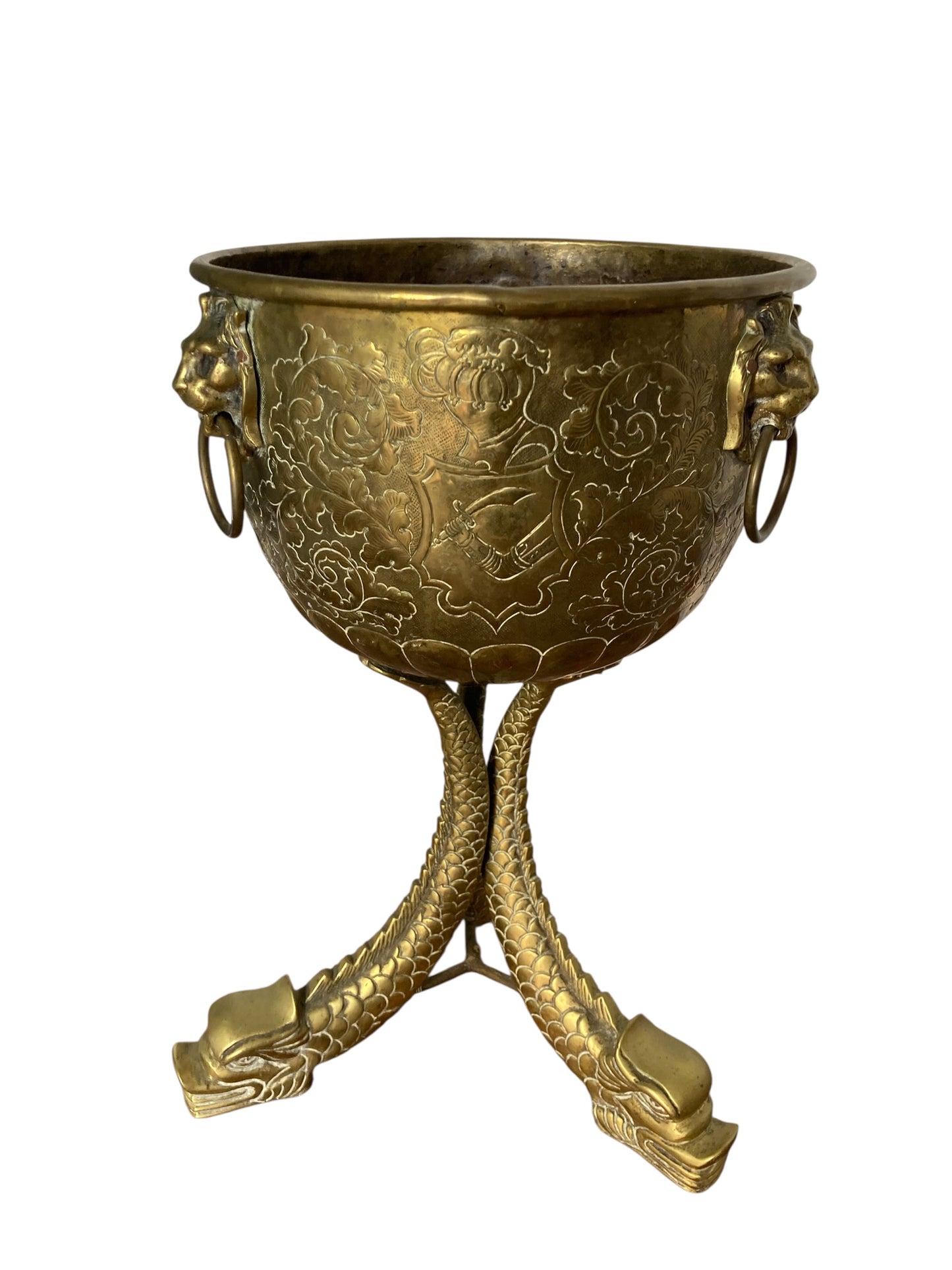An antique brass jardinière or decorative planter