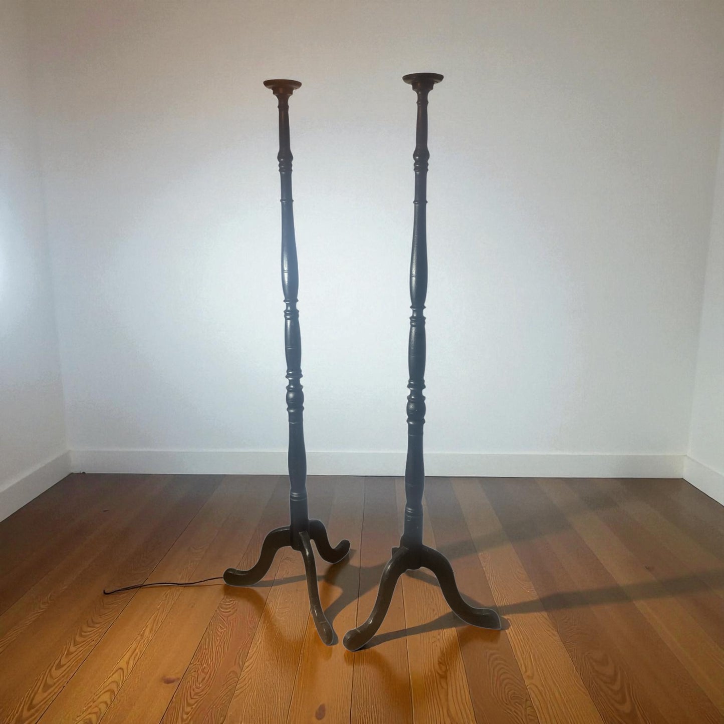 A pair of Tall Ebonised Tri Leg Torcheres