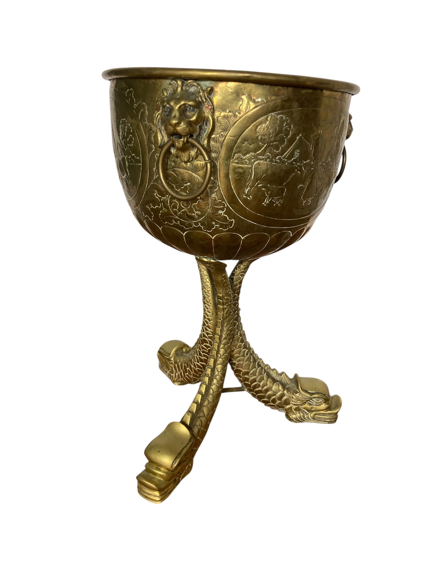 An antique brass jardinière or decorative planter