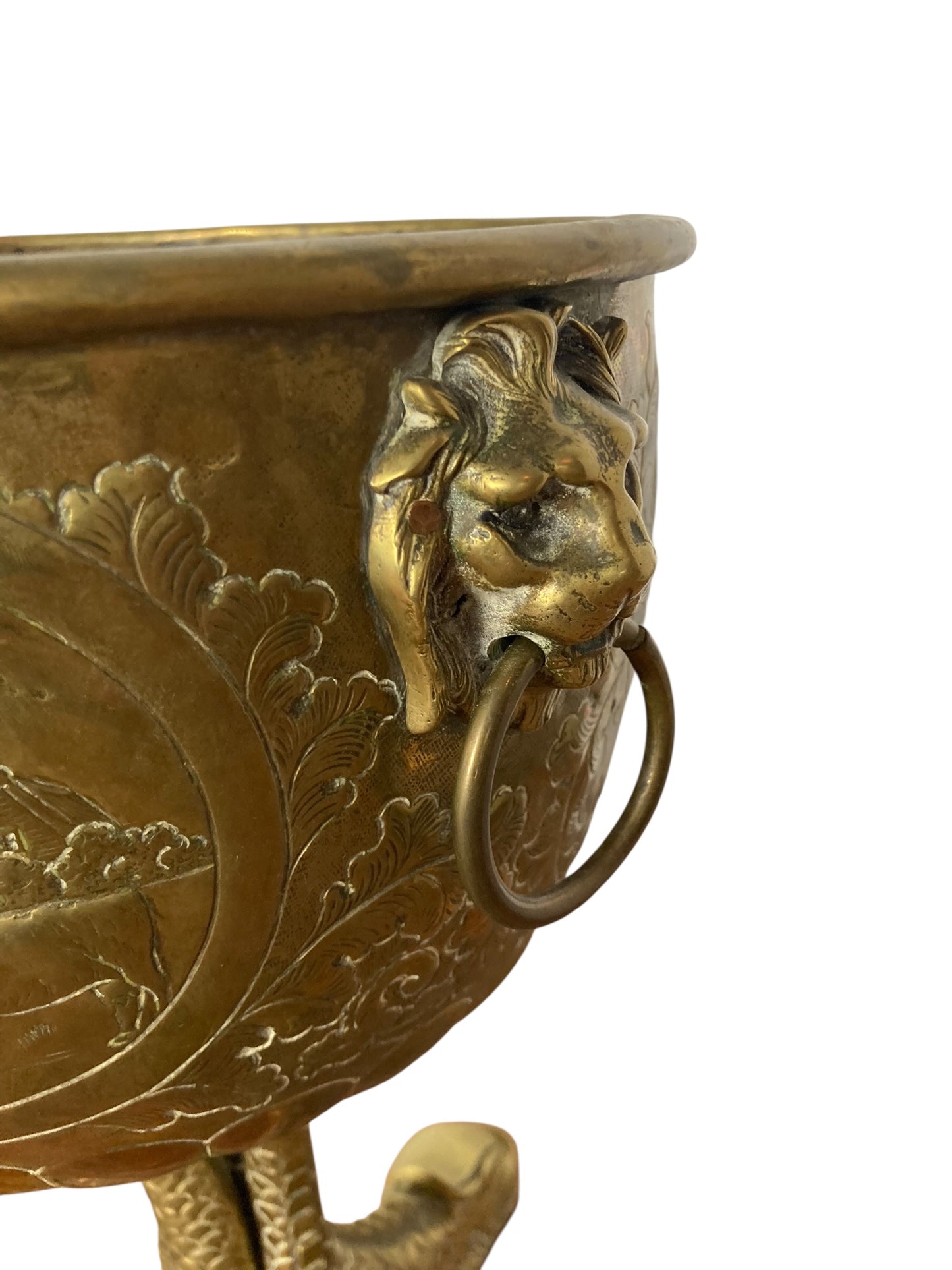 An antique brass jardinière or decorative planter