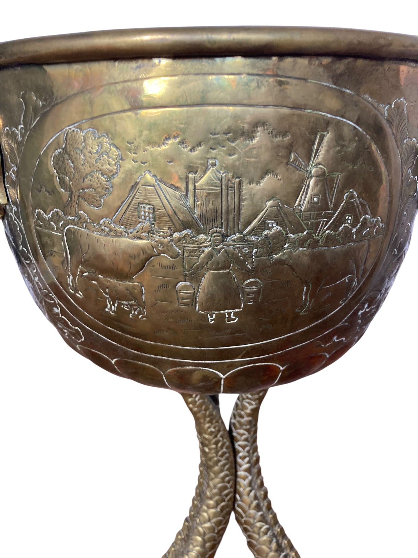 An antique brass jardinière or decorative planter