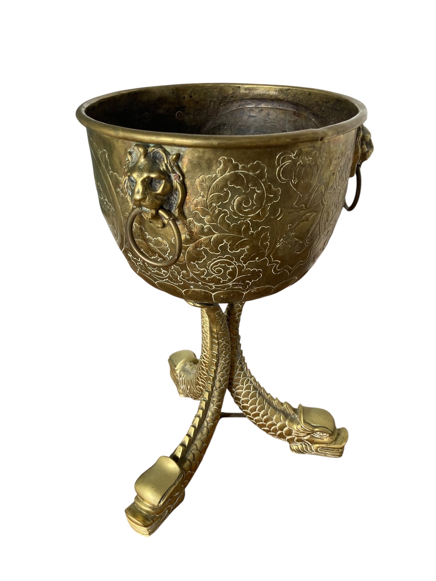 An antique brass jardinière or decorative planter