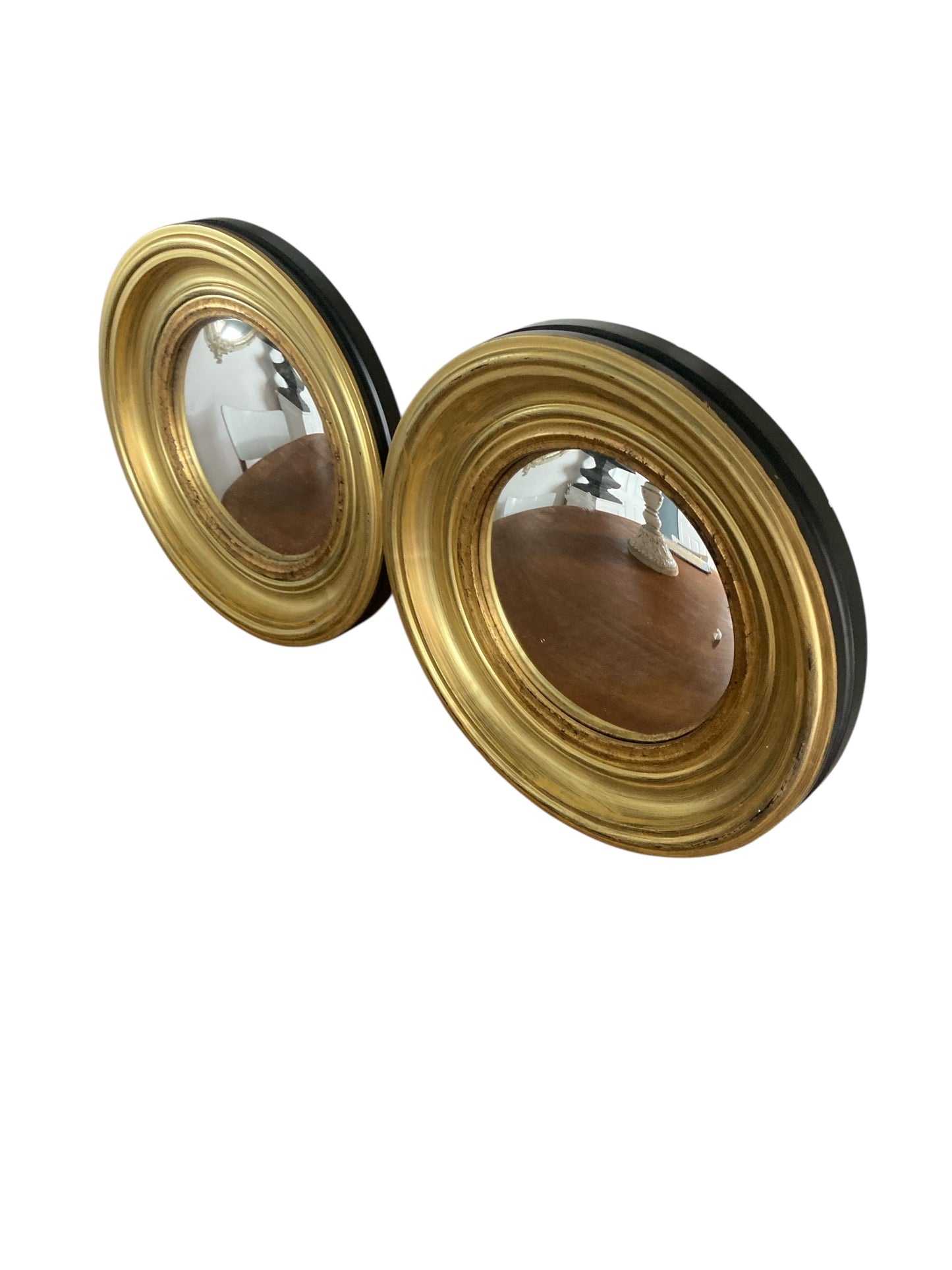 A Pair of Modern Regency Style Gold Circular Convex Mirrors with ebonsied Rim