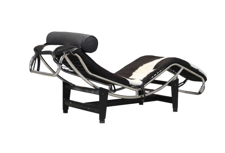 An 'LC4'  Le Corbusier Style chaise longue,upholstered in pony hide and with a black leather neck roll cushion to the chromium-plated tubular frame,