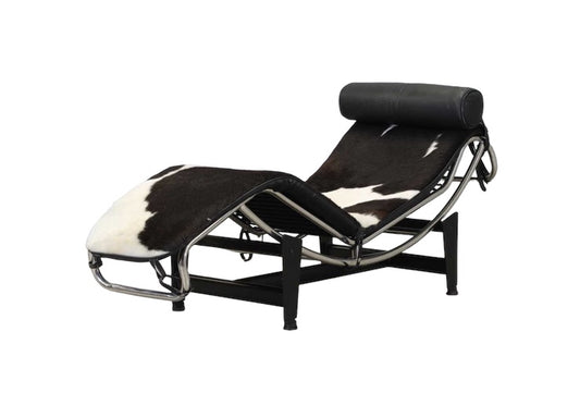 An 'LC4'  Le Corbusier Style chaise longue,upholstered in pony hide and with a black leather neck roll cushion to the chromium-plated tubular frame,