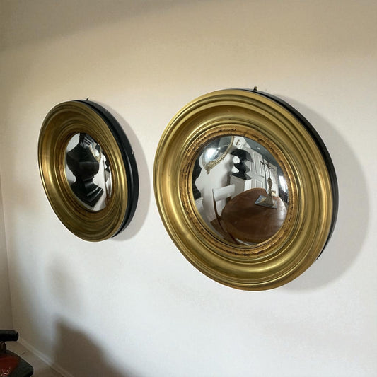 A Pair of Modern Regency Style Gold Circular Convex Mirrors with ebonsied Rim